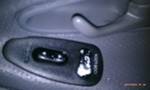 1994 Ford Probe - Close-up of a car's interior door panel, showing the lock switch and handle mechanism.