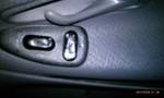 1994 Ford Probe - Close-up of power seat controls located on the interior door panel of a vehicle.