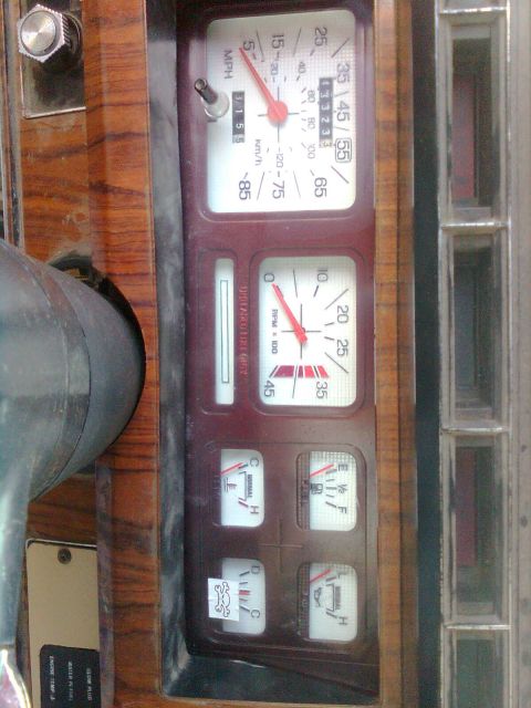 1984 Ford Bronco - Close-up of a vehicle's interior dashboard gauges, including a speedometer and tachometer.