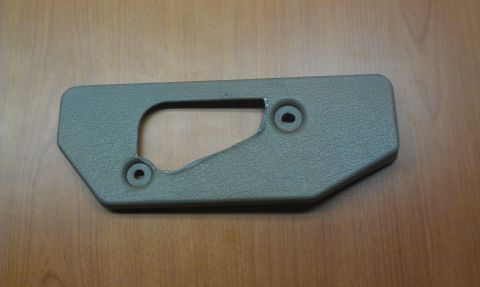 1991 Ford Festiva - This is a tan plastic interior trim piece with a cutout and two mounting holes.