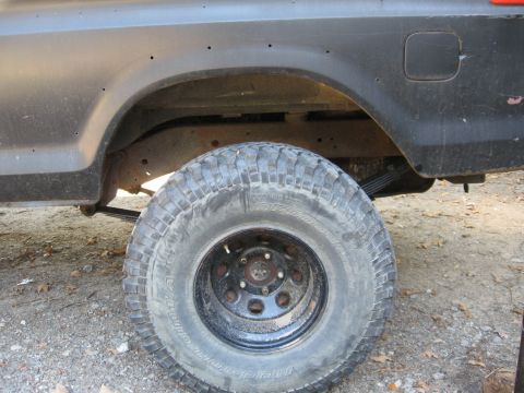 1978 Ford Bronco - Close-up of the rear wheel and fender of a 1978 Ford Bronco with off-road tires.