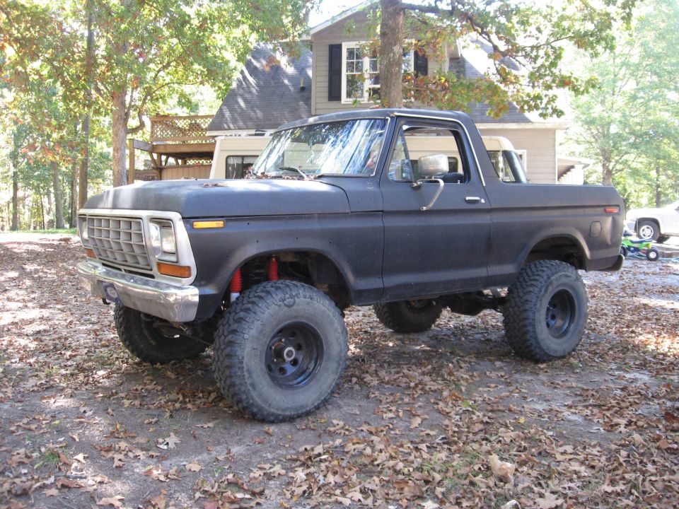 1978 Ford Bronco with a lift kit and large off-road tires parked outdoors