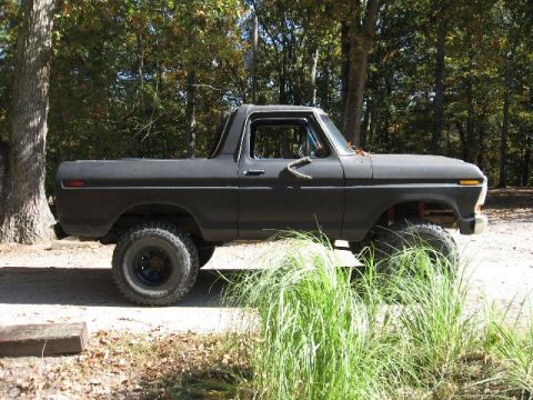 1978 Ford Bronco - This lifted 1978 Ford Bronco is parked outdoors with trees in the background.