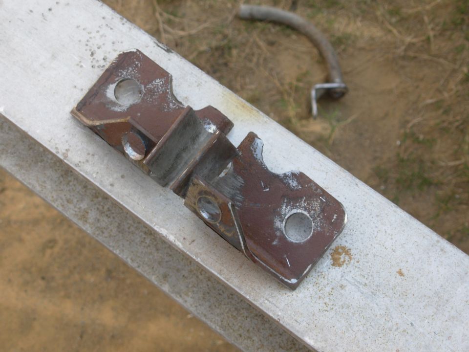 I finally came up with an idea for the the e-brake cable brackets that eliminates one set of tubes, and doesn't need any extra bolts or welding to the trailer.