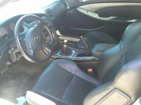 2008 Subaru Legacy - The interior of the vehicle shows black leather seats and a manual transmission shifter.