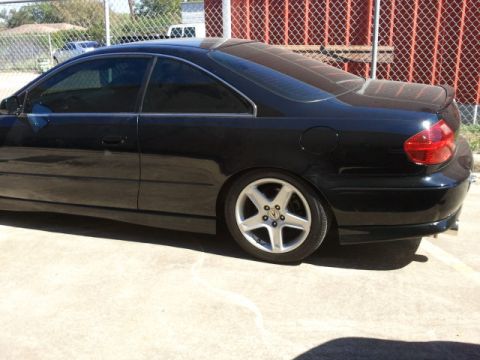 2008 Subaru Legacy - The rear quarter panel and taillight of a black coupe are visible.