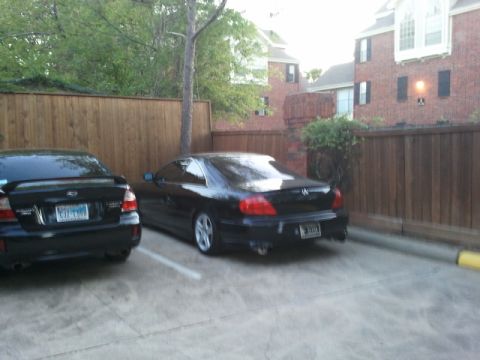 2008 Subaru Legacy - Two cars parked in a lot, one is a Subaru Legacy wagon and the other is an Acura coupe.