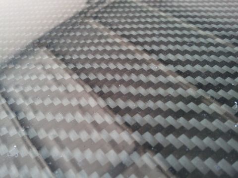 2008 Subaru Legacy - A close-up view of a carbon fiber pattern on a vehicle component, including a website logo.