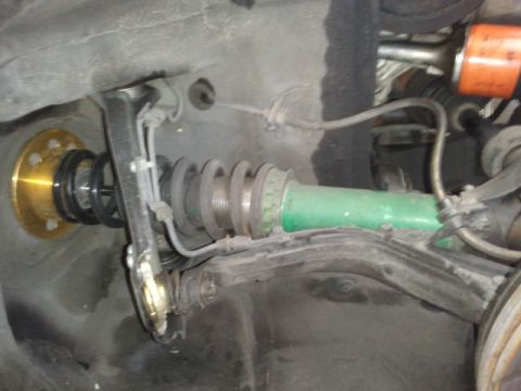 2008 Subaru Legacy - Adjustable coilover suspension part, likely for the front of a car.