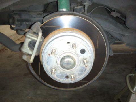 2008 Subaru Legacy - This image shows a close-up view of a vehicle's rear brake system, including the rotor and caliper.