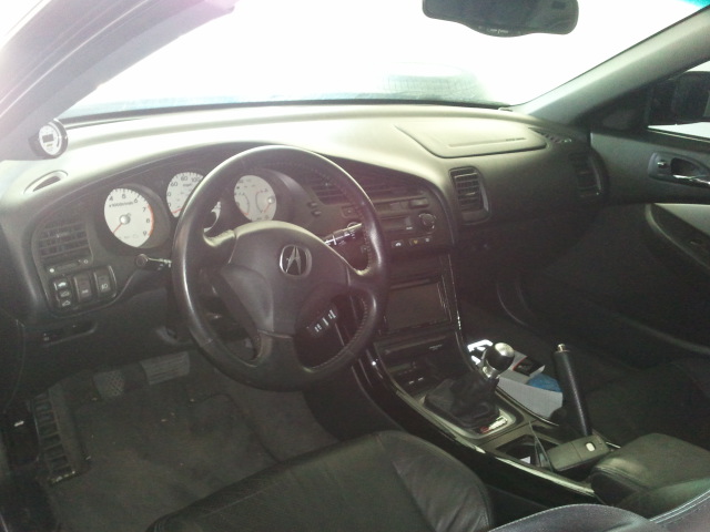 Car interior with Acura logo on steering wheel and white-faced gauges