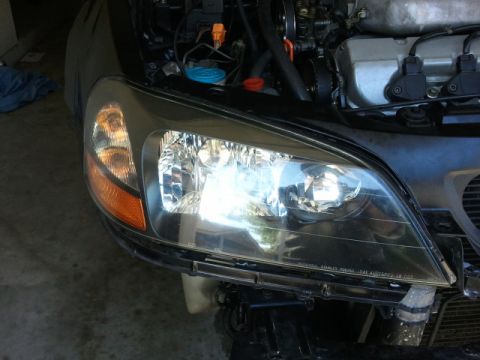 2008 Subaru Legacy - Headlight assembly and engine bay detail of a car, with 'STANLEY' visible on the headlight lens.