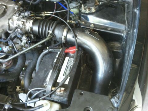 2008 Subaru Legacy - Close-up view of an engine bay, highlighting the battery and intake system components.