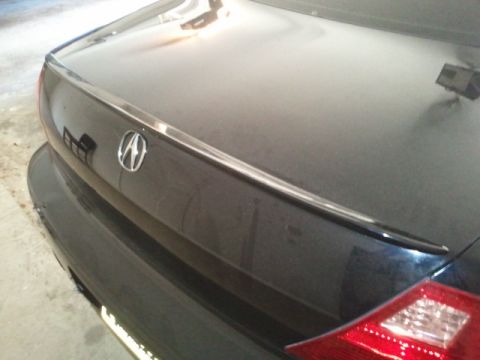 2008 Subaru Legacy - The Acura emblem is visible on the trunk of a dark-colored car.