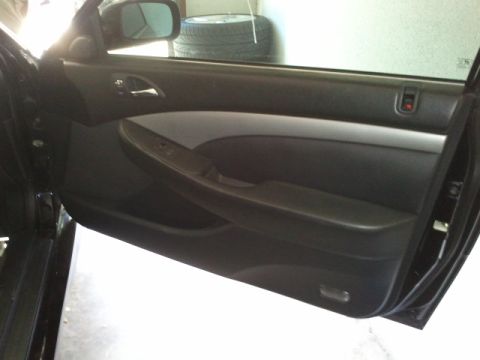 2008 Subaru Legacy - Interior view of a car's black door panel, a silver accent strip and integrated armrest.