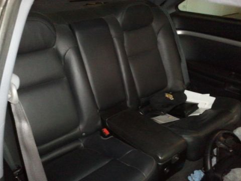 2008 Subaru Legacy - The rear seats of a car are shown, with a center armrest folded down.