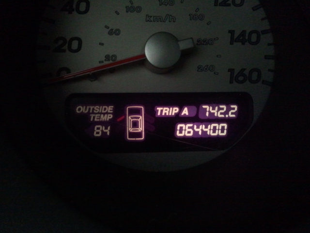 Car dashboard showing 84 degrees Fahrenheit outside temperature and 64,400 miles on the odometer