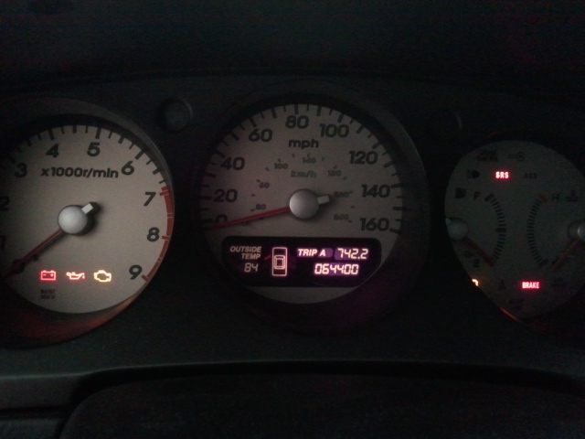 Dashboard gauges showing 84 degrees outside temp, trip A at 742.2, and 064400 miles
