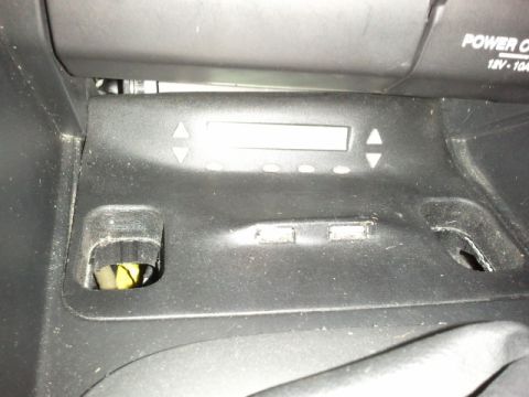 2008 Subaru Legacy - Close-up of car interior controls, including a digital screen and power outlet information.
