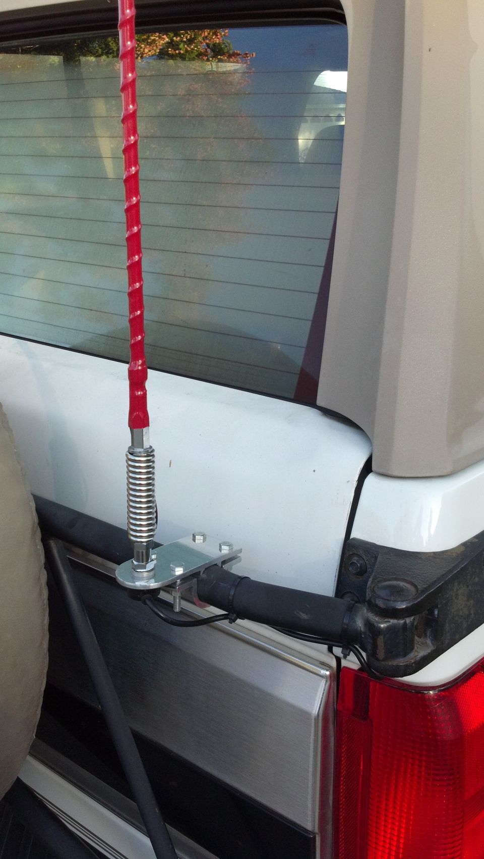1996 Ford Bronco rear with red CB antenna mounted on the tailgate hinge