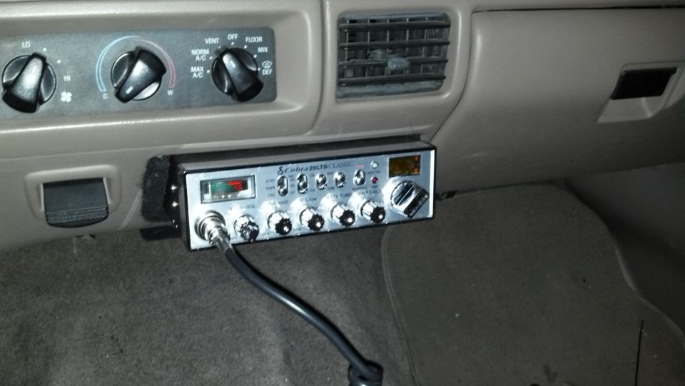 CB radio mounted below dashboard air vents and climate controls