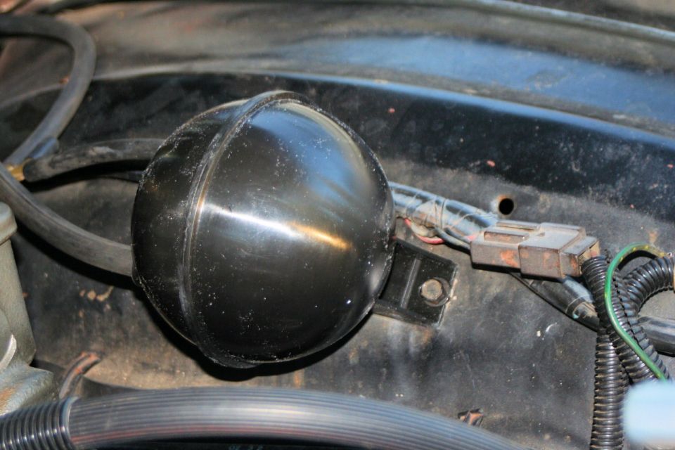 Black spherical vacuum reservoir with a metal bracket and electrical connector