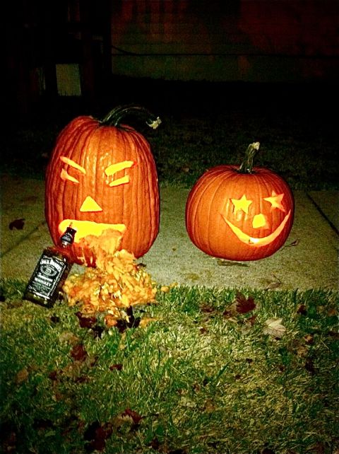 1995 Ford F-150 - Halloween pumpkins carved with faces and a bottle of whiskey sit on the grass at night.
