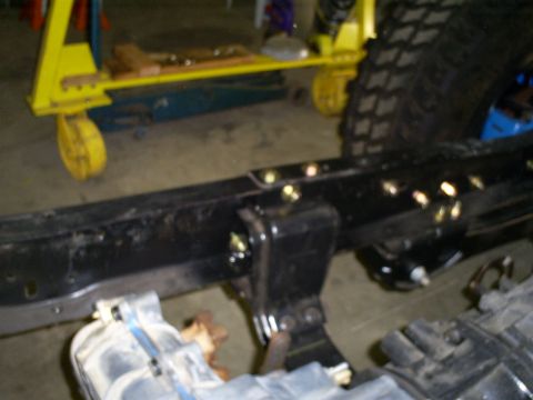1992 Ford Bronco - The image shows a close-up view of a vehicle's frame and suspension system, with a large tire in the background.