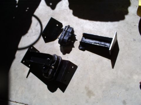 1992 Ford Bronco - Several engine mounts are laid out on a concrete floor.