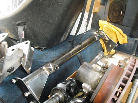 1986 Ford Bronco - Various automotive parts, including suspension components and a brake rotor, are visible on the floor of a vehicle.