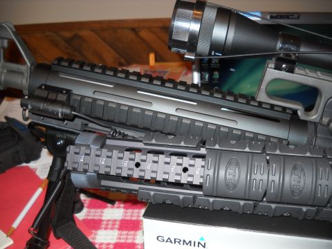 2012 Ford Mustang - A tactical rifle with a scope and bipod is shown in a close-up view, highlighting its various attachments.