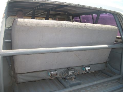 1979 Ford Bronco - Interior view of a vehicle's rear seating area, showing a roll cage and seat.
