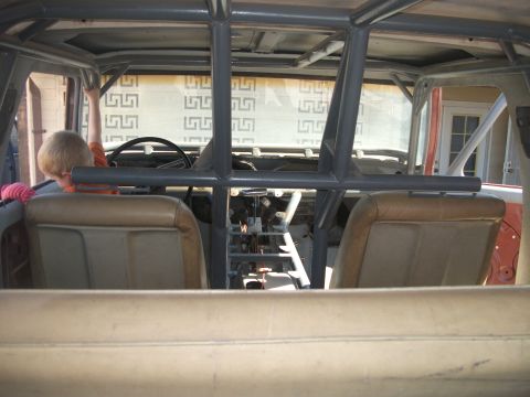 1979 Ford Bronco - The interior of a 1979 Ford Bronco is visible, a roll cage and tan upholstery.