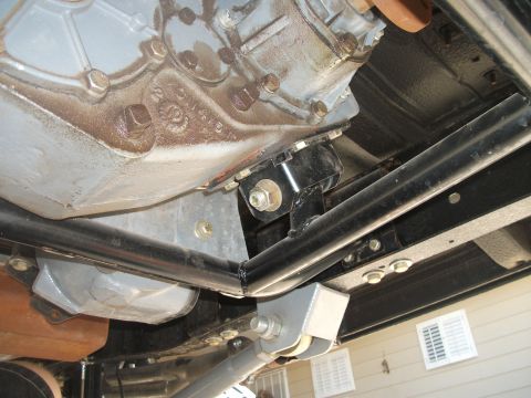 1979 Ford Bronco - Close-up of vehicle drivetrain components, showing the transfer case and transmission mounts.