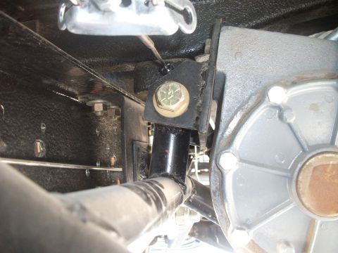 1979 Ford Bronco - Underside view of a vehicle's transfer case mounting bracket and related hardware.