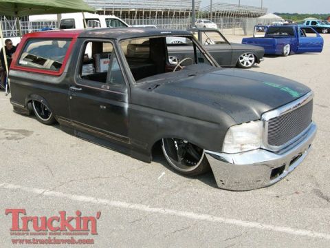 1986 Ford Bronco - This heavily modified SUV features a two-tone paint scheme and a slammed stance.
