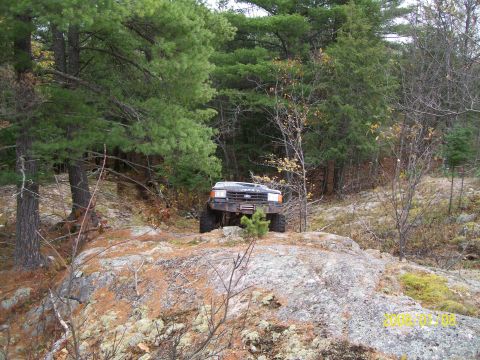 1988 Ford F-250 - 1988 Ford F-250 navigating challenging off-road terrain.