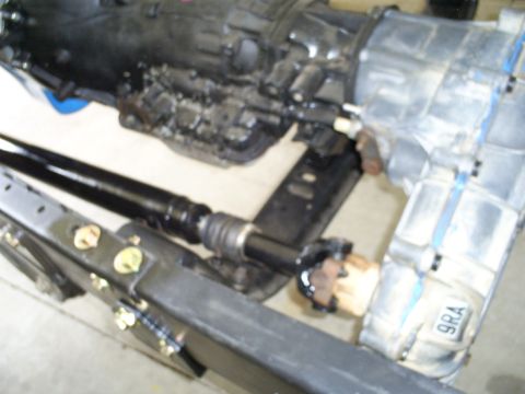 1992 Ford Bronco - Transmission and driveshaft assembly, possibly from a 1992 Ford Bronco, with a visible part number tag.