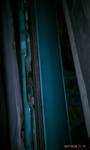 1994 Ford Probe - Close-up view of a teal door panel, revealing exposed wiring and internal metal structures.