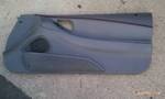 1994 Ford Probe - A gray car door panel, likely for a coupe, is shown flat against a concrete surface.
