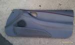 1994 Ford Probe - A gray car door panel is shown lying flat on a rough surface.