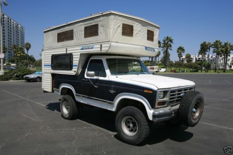 1986 Ford Bronco - This 1986 Ford Bronco is equipped with a camper shell and a spare tire mounted on the front bumper.