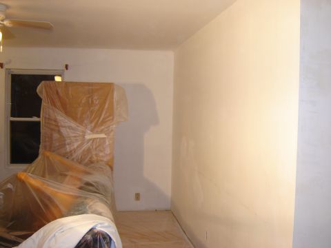 1984 Ford Mustang - A room appears to be undergoing renovation, with furniture covered in protective plastic sheeting.
