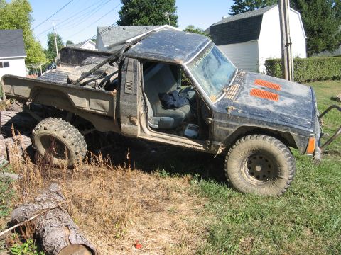 1987 Jeep Comanche - This 1987 Jeep Comanche shows modifications for off-road adventures, including a roll cage and large tires.