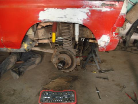 1980 Ford Bronco - Vehicle undergoing repair work, focusing on the suspension and wheel area.