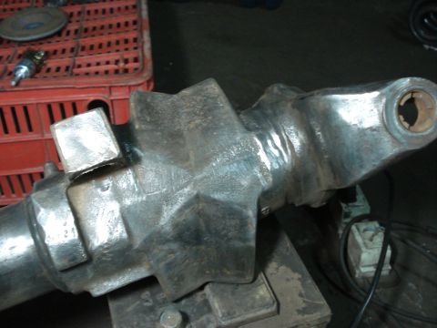 1980 Ford Bronco - Close-up of a metal axle component with visible welds and a star-shaped flange.