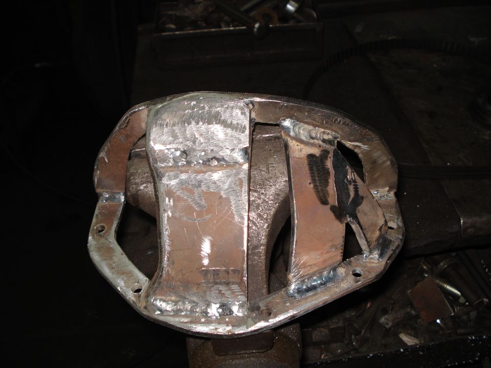 Welded differential housing with visible weld marks and mounting holes