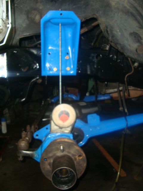 1980 Ford Bronco - A close-up view of a vehicle's suspension system, focusing on a painted component and assembled component.