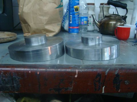 1980 Ford Bronco - Two metal spacers are visible on a workbench, with a teapot and mug in the background.