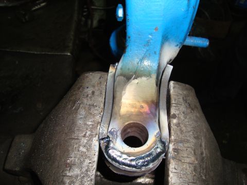 1980 Ford Bronco - A metal component is secured in a vise, displaying recent welding work.